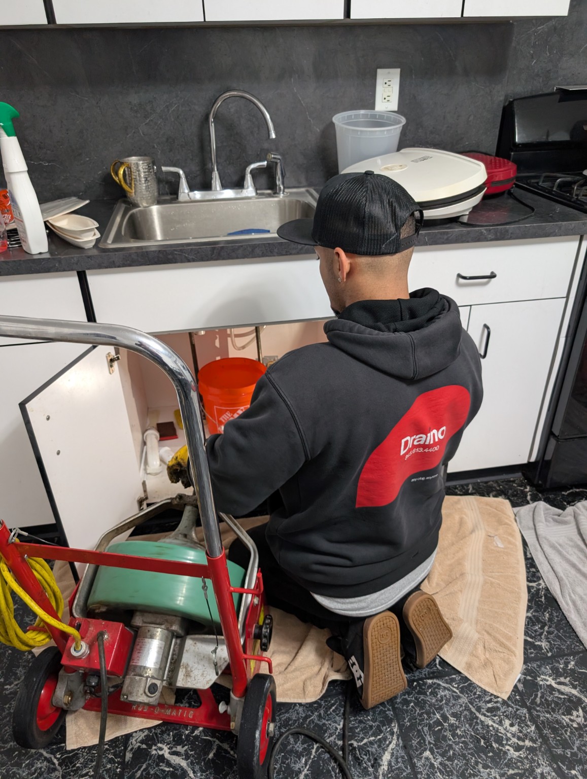 Draino technician clearing a kitchen line